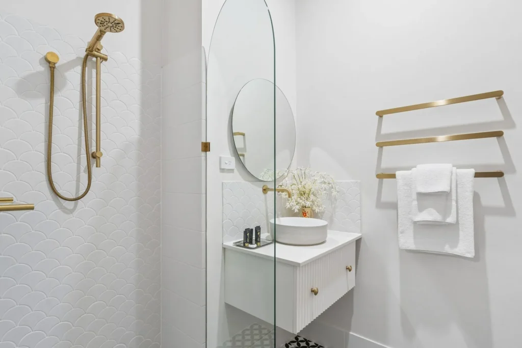 Scallop tile and brass fittings in the Amber bathroom